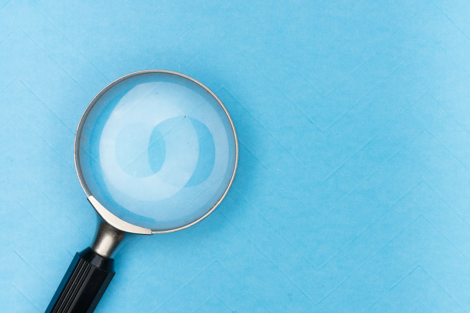 Magnifying glass on white table